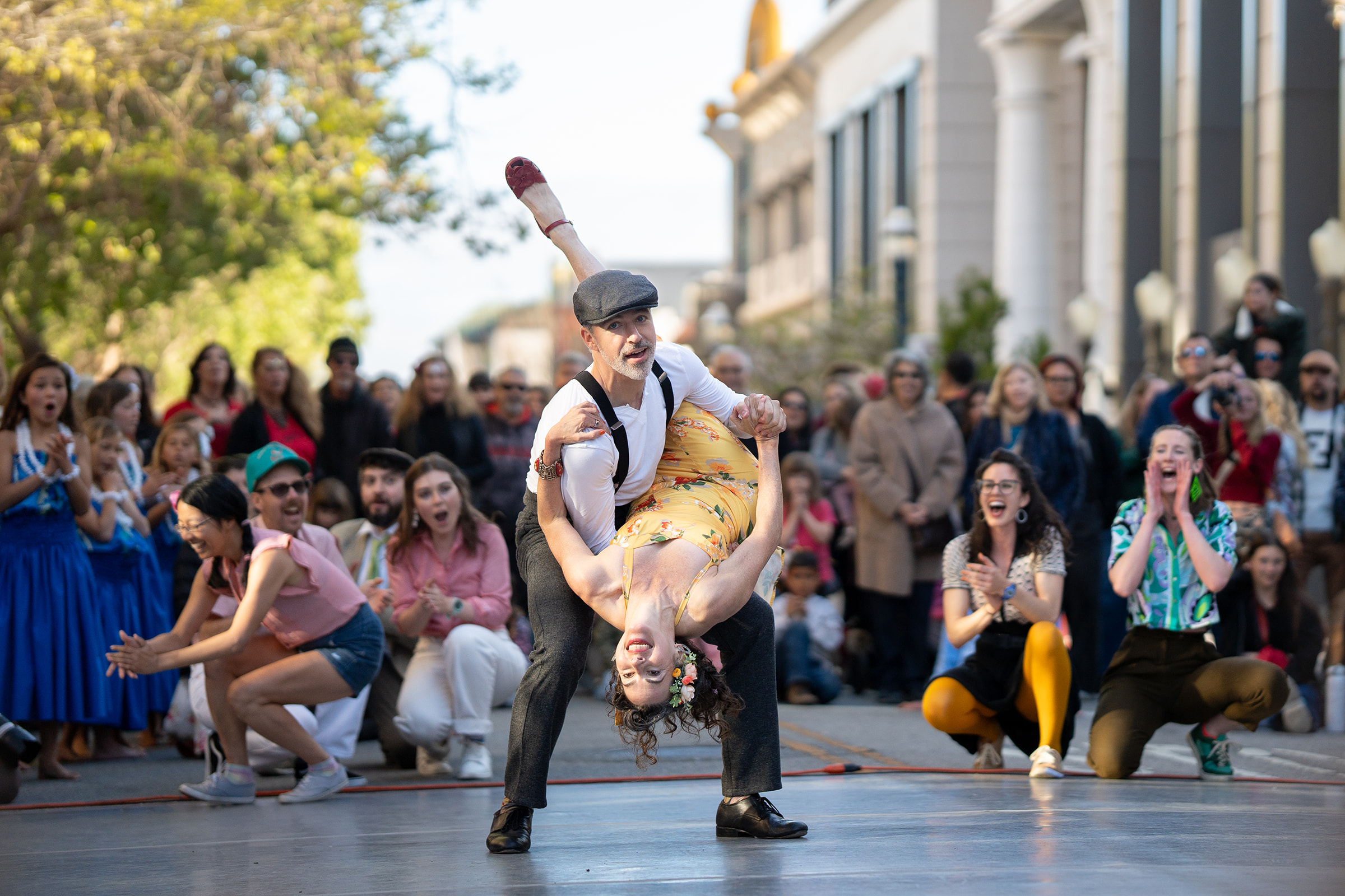 Evan performing a swing dance dip at a public event